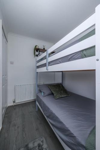 a bedroom with two bunk beds and a wooden floor at 2 bed house Barton Green, Clifton Nottingham in Nottingham