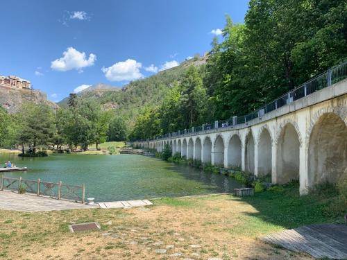 a bridge over a river with a boat on it at Aroma Cite Vauban in Briançon