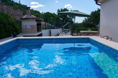 a swimming pool with blue water in a house at Apartments Sanja in Karlobag