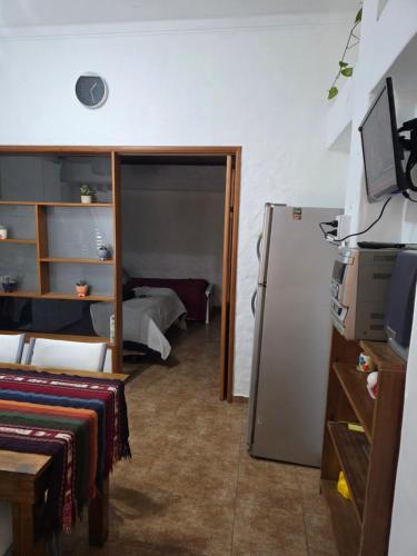 a room with a refrigerator and a room with a bed at Tolouse 1 in Tolosa