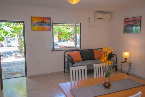 a living room with a couch and a table at Apartments Sanja in Karlobag