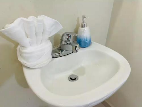 a white bathroom sink with a soap dispenser on it at House w Ocean View and Balcony in Rosarito Beach