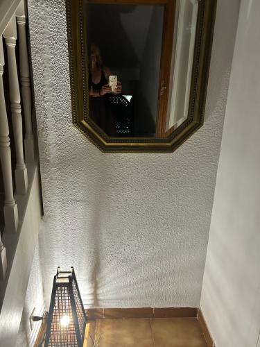 a woman taking a picture of herself in a mirror at Atardeceres & Jacuzzi in La Manga del Mar Menor