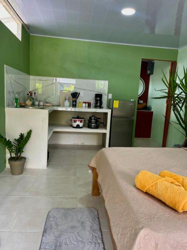 Una habitación con cocina y una cama en ella. en Pura Vida Estudio, en Puerto Jiménez