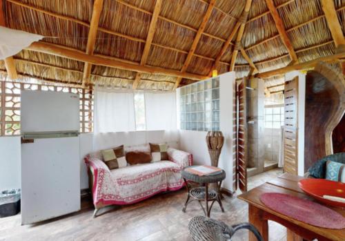 a living room with a couch and a table at Aventura Pacifico Boutique Suites & Villas in Bucerías