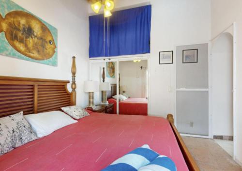 a bedroom with a large bed and a blue cabinet at Aventura Pacifico Boutique Suites & Villas in Bucerías