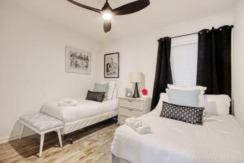 a bedroom with two beds and a ceiling fan at Ocean Forest Villa Beach Side Oasis in Myrtle Beach