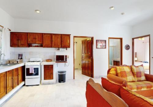 a kitchen and a living room with a couch at Aventura Pacifico Boutique Suites & Villas in Bucerías