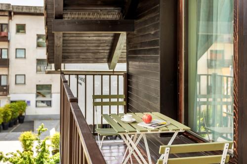 a balcony with a table and chairs on a building at Guest House The Hive in Bled