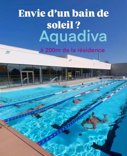 a swimming pool with people in the water at Le refuge Marin - Mer, Piscine, Vélo & Loisirs à 2 pas in Cabourg