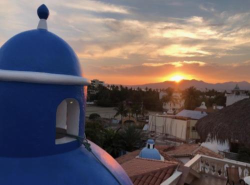 a view of the sunset from the roof of a house at Aventura Pacifico Boutique Suites & Villas in Bucerías