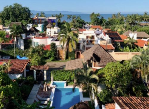 a view of a city with houses and the ocean at Aventura Pacifico Boutique Suites & Villas in Bucerías