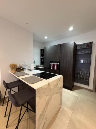 a kitchen with a island with a counter top at Cute little Penthouse in the Heart of Sliema in Sliema