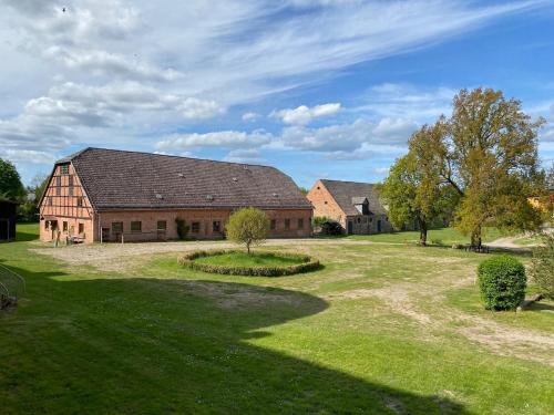 a large barn with a grassy yard in front of it at Neuensund Manor Entire Inspectors House in Neuensund