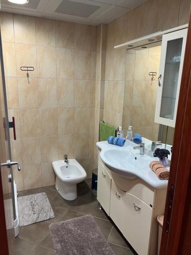 a bathroom with a sink and a toilet at Seashell Hideaway Apartment in Pržno