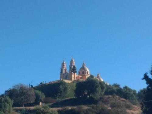 a castle on top of a hill at El rinconcito in Cholula
