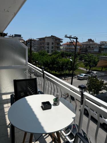 a white table and chairs on a balcony at C14 Apartment 1 in Paralia Katerinis