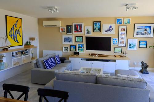 a living room with a couch and a flat screen tv at Villa Bellevue in Albufeira