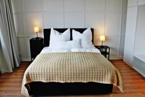 a bedroom with a large bed with white pillows at Apartment In SI-Centrum in Stuttgart