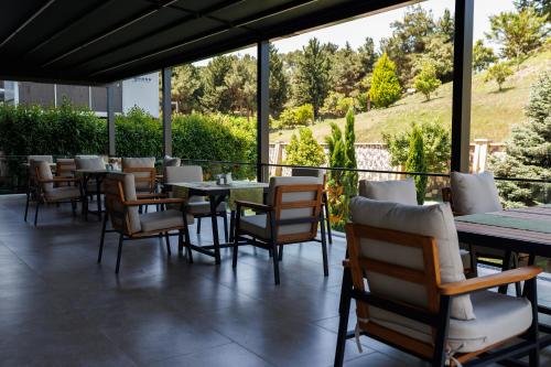 a restaurant with tables and chairs on a patio at Ayan Palace Hotel in Tovuz