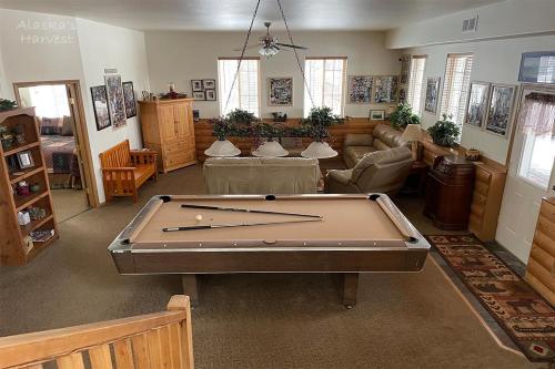 a living room with a pool table in it at Alaska's Harvest Bed and Breakfast and Luxury Log Cabin in Palmer