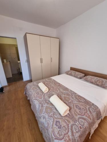 a bedroom with a bed with two towels on it at Villa Panorama in Pridraga