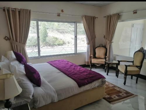 a bedroom with a large bed and a large window at Hotel Dee waterfall view kutten in Kundālshai