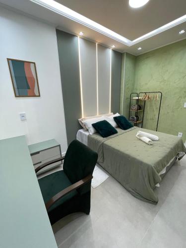 a bedroom with a bed and a chair in it at Paraíso no coração da Lapa in Rio de Janeiro