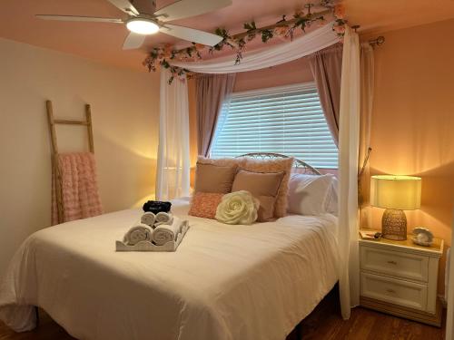a bedroom with a white bed with a window at NEW Beach Home with Canopy Bed and Work Spaces in Manhattan Beach