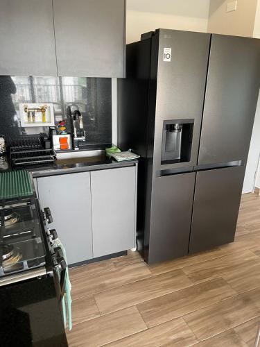 a kitchen with a refrigerator and a sink at Panama Pacifico PH Downtown in El Quije