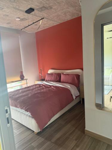 a bedroom with a red wall and a bed at Panama Pacifico PH Downtown in El Quije