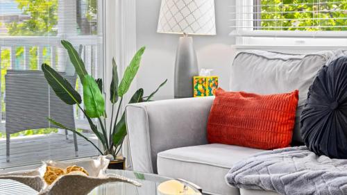 a living room with a chair with a red pillow at 2BR Beach Escape - Walk to Boardwalk - Parking in Ocean City