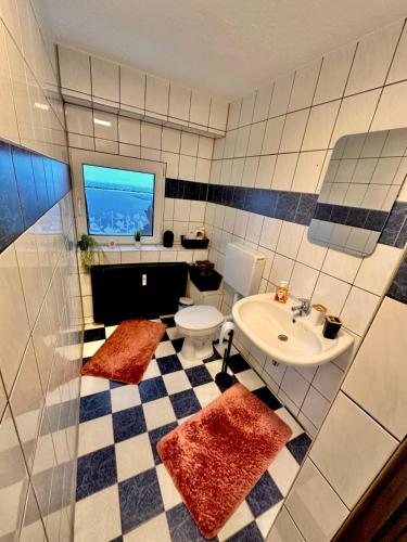 a bathroom with a toilet and a sink at Infinity-Flat Würselen City in Würselen