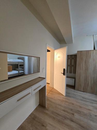 an empty room with a kitchen and a door to a room at Voyage Villa in Vlorë