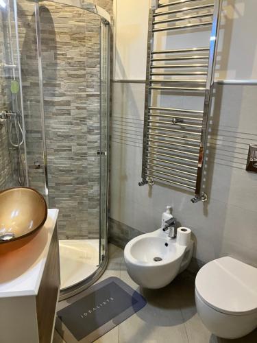 a bathroom with a sink and a toilet and a shower at Bibi Pied-à-Terre Vetra - Two Rooms Apartment in Milan