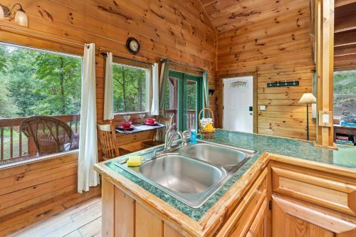 a kitchen with a large sink in a cabin at Pine Ridge in Sevierville