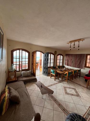 a living room with a bird sitting on the floor at surf trip in Kasba Bou Hamira