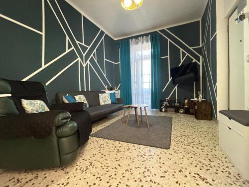 a living room with a couch and a table at Lyhnida Vacation Home in Imperia