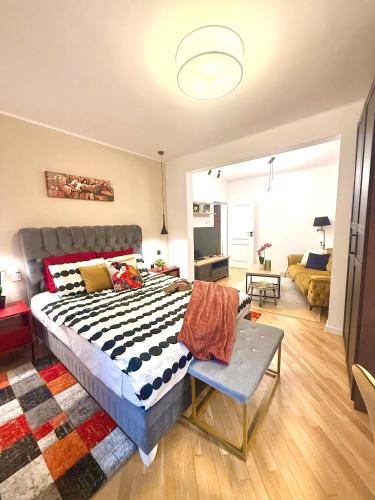 a bedroom with a large bed and a living room at Luxury apartment in the heart of Sofia in Sofia