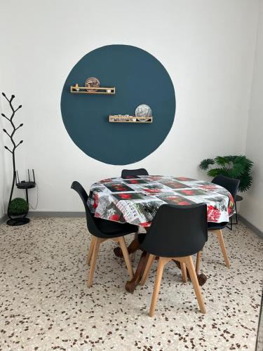 a dining room with a table and two chairs at Lyhnida Vacation Home in Imperia
