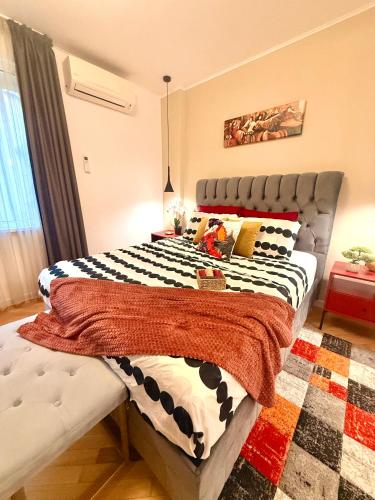 a bedroom with a bed with a black and white comforter at Luxury apartment in the heart of Sofia in Sofia