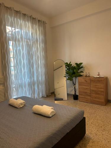 a bedroom with a bed and a dresser and a window at Lyhnida Vacation Home in Imperia
