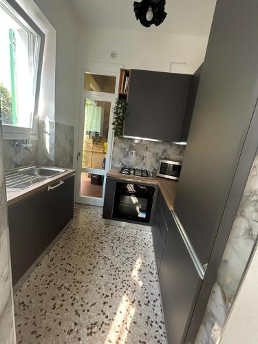 a kitchen with a sink and a stove at Lyhnida Vacation Home in Imperia
