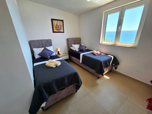 Postel nebo postele na pokoji v ubytování Apartments Liana - VaLa