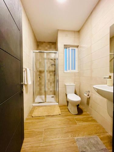 a bathroom with a shower and a toilet and a sink at See You Diego Court in St. Paul's Bay
