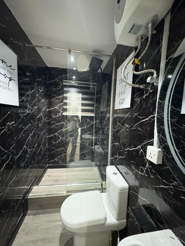 a bathroom with a toilet and a shower at Shortlet By Loveline in Ibadan