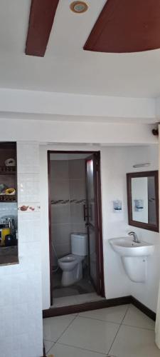 a bathroom with a toilet and a sink at Warda Apartment 2 Bedrooms in Lamu
