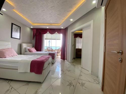 a hotel room with two beds and a hallway at Beyaz motel in Erdemli