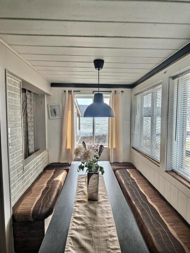 a living room with a table and a large window at Sheldon Cottage in Laurentides Quebec in Rivière-Rouge