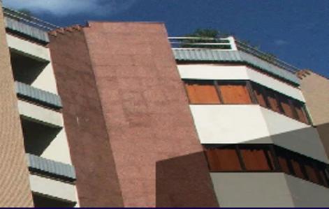 a tall building with brown and white at Crystal Apart Hotel in Macaé